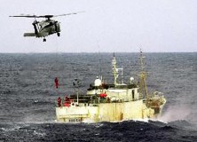 Members of the Australian navy fastrapel from a helicopter launched from HMAS Canberra to arrest the Volga